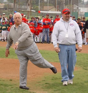 Dodger great Tommy tosses the traditional first pitch to kick off La Verne Little League's opening-day ceremonies at Pelota Park as League Vice President Brian Shively looks on. 