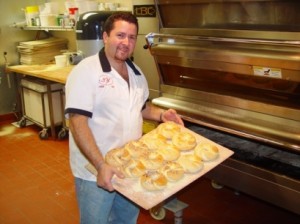 Sal's ready to serve some fresh bagels hot out of the oven.