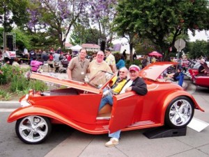 Pictured, from left, are Dan Maydeck, President and CEO of LeRoy Haynes Center; Brian McNerney, President and CEO of the La Verne Chamber of Commerce; Connie LaMarche, President and Founder of Cruisin' La Verne; and car owner Charlie Tachdjian.  The classic rock and roll band "The Answer" performs in the background.