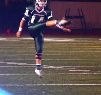 Punter, Passer, Kicker, Wide Receiver, Evan Highley kicked field goals of 42 and 47 yards and constantly pinned the Wildcats deep in their own territory with booming punts. Here he almost elevates off the page.