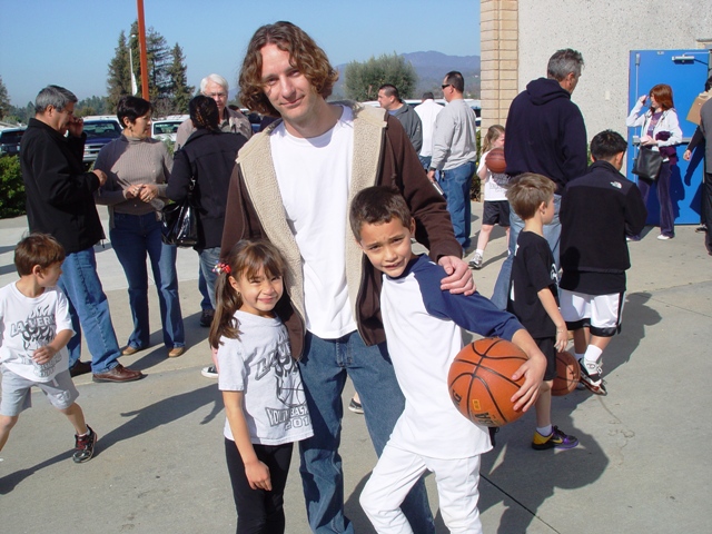 Coach Eckler with his two children at a City League basketball game where the stakes aren't quite as high.
