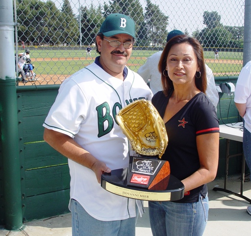 Parents Fausto and Letty Mier hold Rawlings Gold awarded to their son Jiovanni Mier for being the best defensive high school shortstop in 2009.