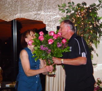Coaches like Mark Miller, handing a bouquet to his lovely wife Linda,  don't get through the season without their family's loving support and patience. 