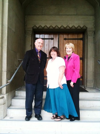 Marlin Heckman, Susan Boyer and Barbara Smythe stand on the steps leading into the sanctuary.