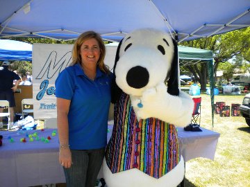 Micky Rehm of Micky's Jewelry Studio and Snoopy share a moment.