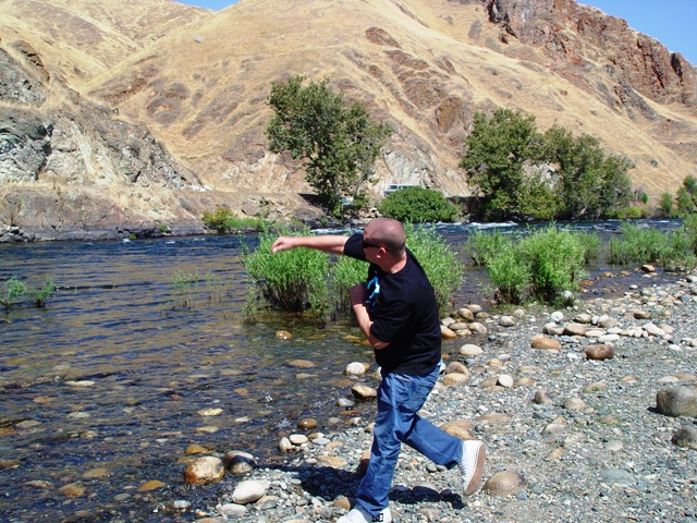 Picnicking and trying to cast stones across the Kings River. Roger cleared the river easily, but the author fell short.