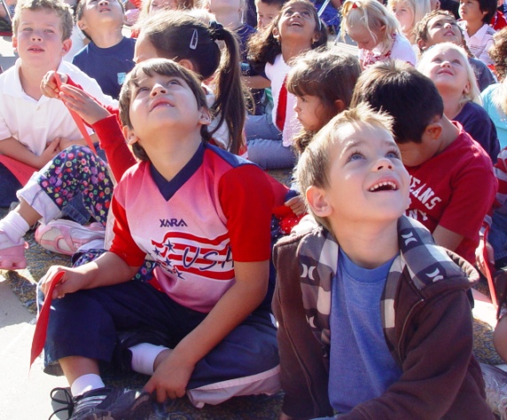 Students look on in awe and amazement as the doves take flight.
