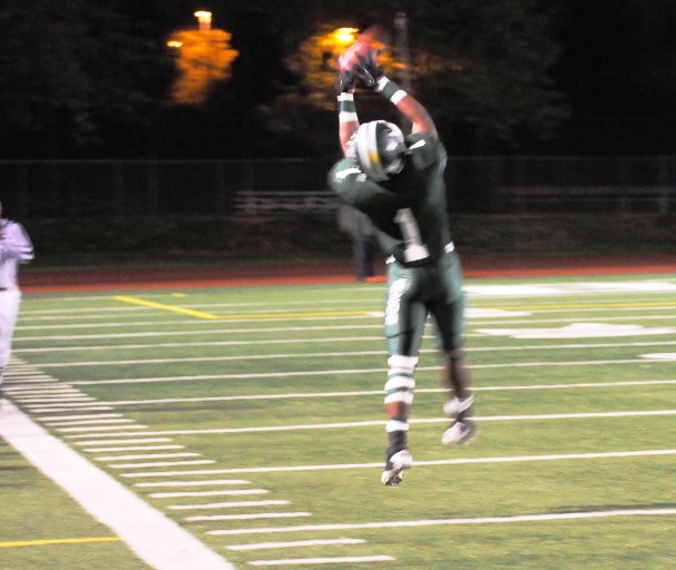 Up, Up and Away: Bonita's Giovani Johnson leaps high to snare a big-gainer from Greg Spathias.
