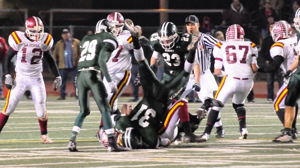 An upended Eric Mikity upends La Serna with approval from No. 29 Toure McCulley and No. 23 Garrett Horine.
