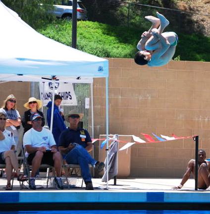 Dylan Galindo somersaults into the pool.