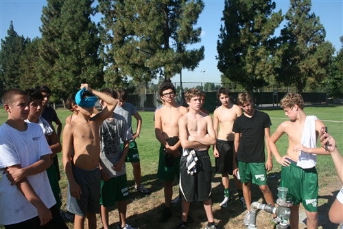 Freshman players exercise outside the pool before they get to make a splash. 