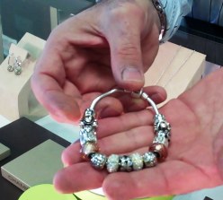 Koko holds a Chamilia bracelet. Design your own or have Koko help you.