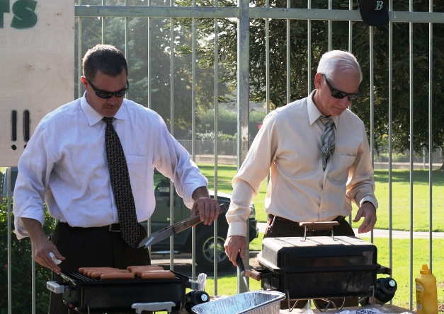 While Assistant Principal Mike MacCormick knows how to cook a mean hot dog, he still hasn't learned how to conceal his tie from grill grit, as demonstrated by his mentor, Principal Bob Ketterling. 