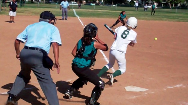 At the crack of the bat, Nikki O' Brien dashes toward first base.
