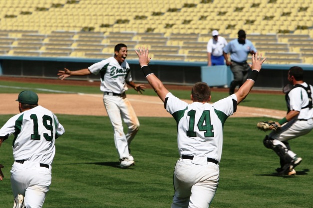 Pitcher Justin Garza is about to be swarmed by his teammates after pitching the Bearcats to a 5-1 victory at Dodger Stadium for the school's first baseball championship since 1951.